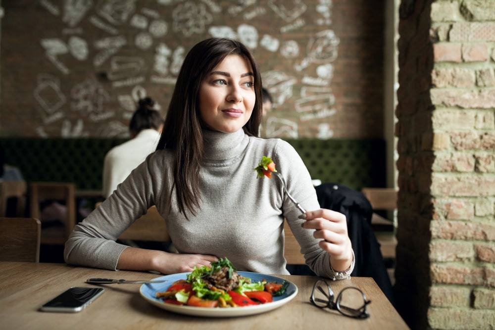 Woman enjoying a balanced, nutritious meal as part of a personalised NutriZaika plan